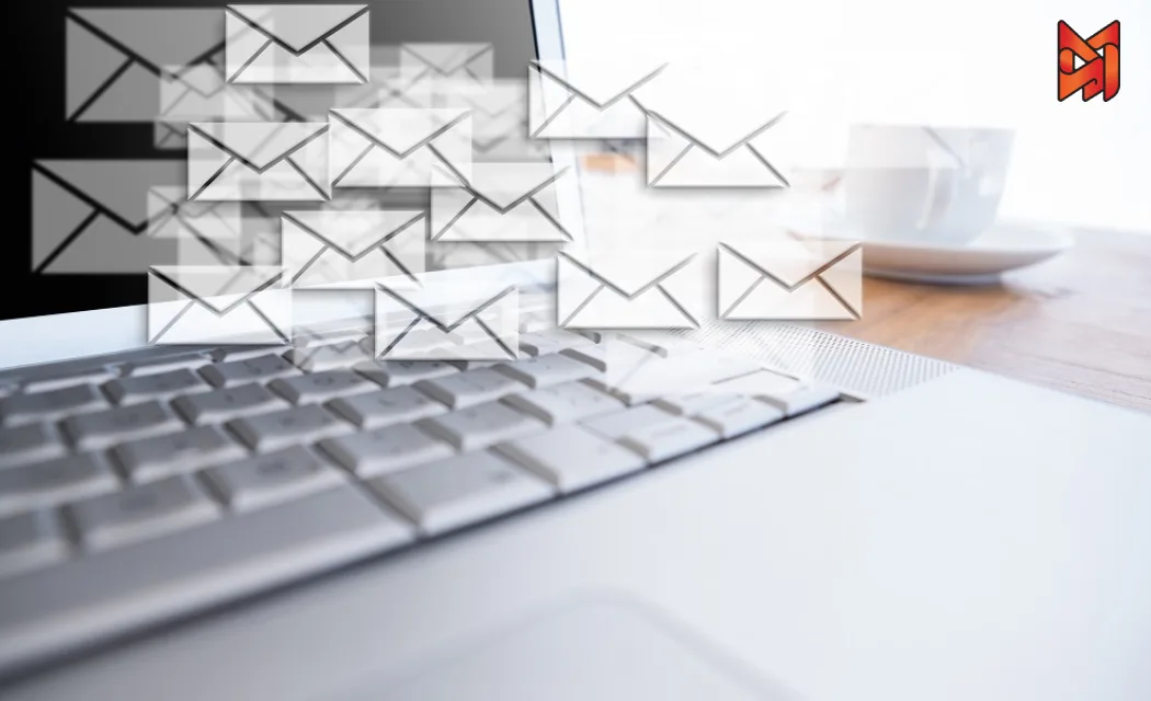 Floating email icons emerging from a laptop, representing email marketing and digital communication.