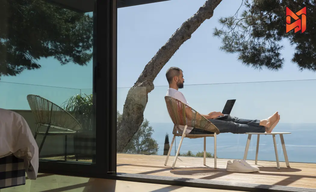 A person enjoying a workday with a view from a modern Airbnb stay in Dubai.