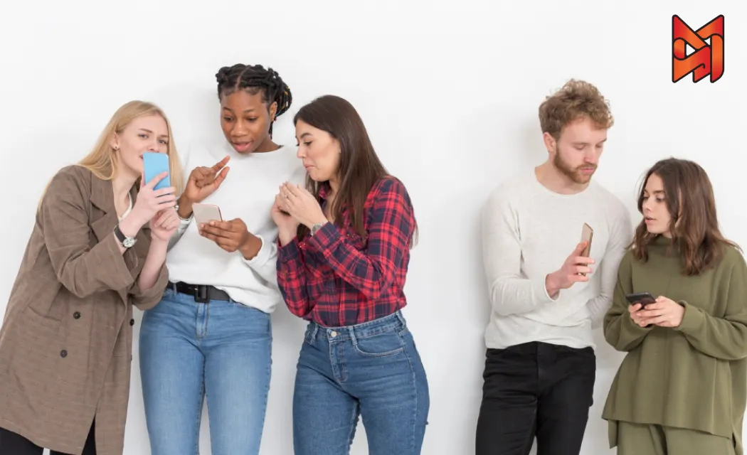 A group of friends engaging with a brand’s online content on their phones, exchanging reactions and tagging friends to join the conversation.