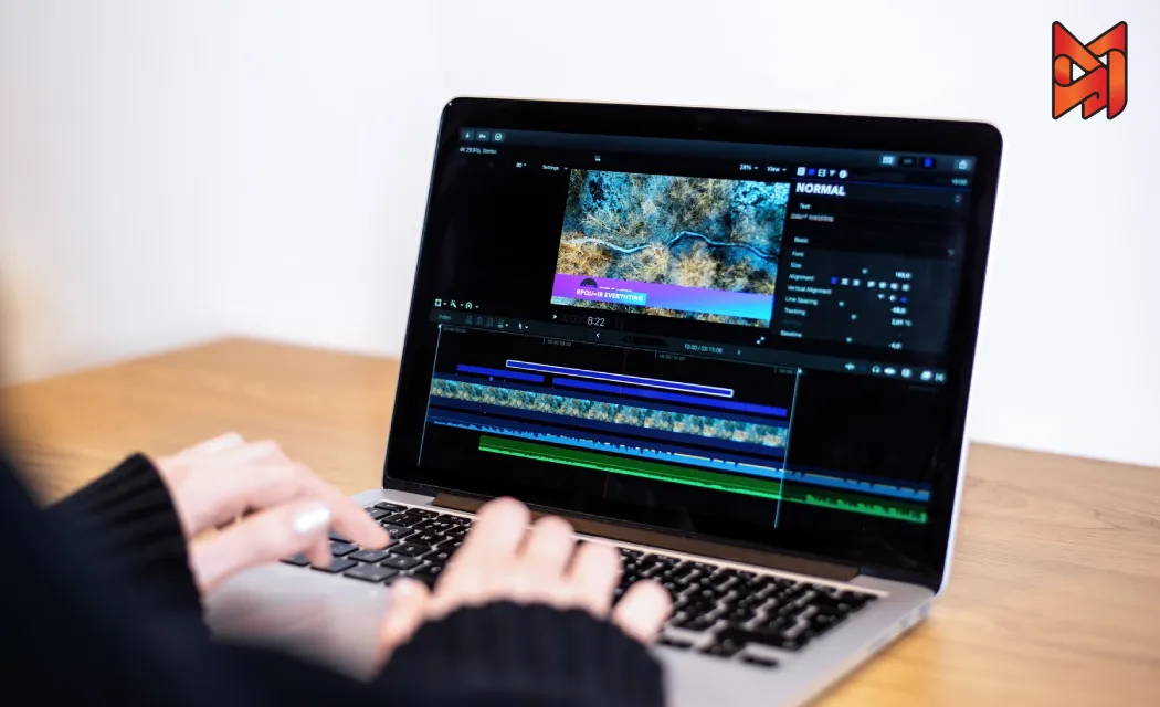 A video creator reviews a video on a laptop, optimizing content with vibrant thumbnails and captions for a video platform.